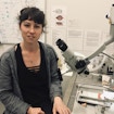 Annegret L. Falkner in front of a microscope