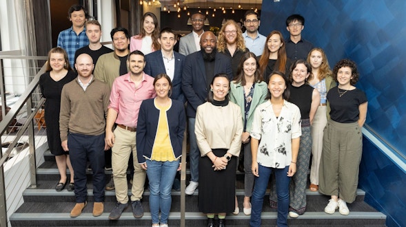 2024 junior fellows arranged as a group on some stairs.