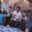 People standing around a table with a tapestry on it