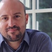 A portrait photo of Otto X. Cordero, a bald man with a short beard and a dark blue collared shirt.