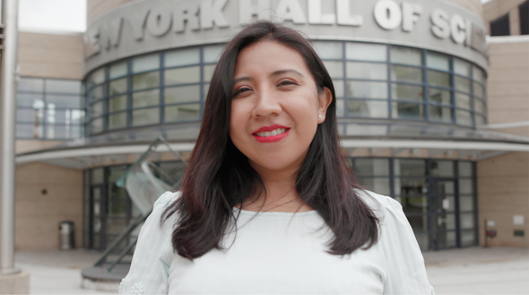 woman standing in front of new york hall of science